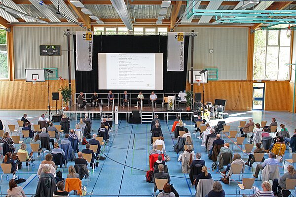 Blick von oben auf das Publikum in der Halle und auf die Bühne.